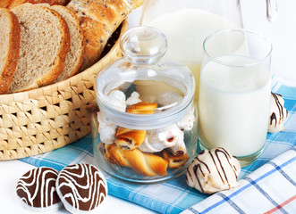 Sliced bread and chocolate chip cookies with milk on checkered t