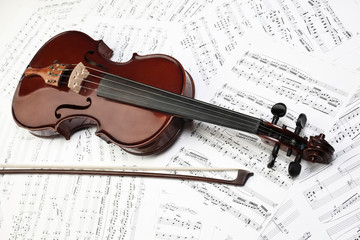 Violin bow with music sheet notes