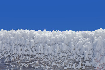 Fototapeta na wymiar Close up of a wooden fence covered with ice crystals