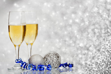 Champagne against holiday lights ang Christmas decorations