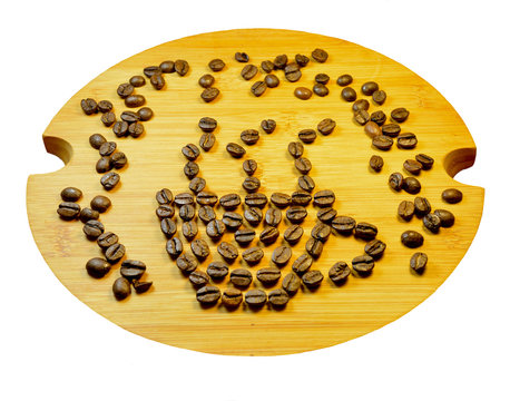 Coffee cup sign made of coffee seeds (beans) on the wooden tray