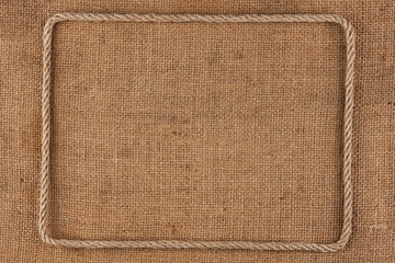 Frame of rope, lies on a background of burlap