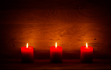 Fototapeta na wymiar candles on the old wooden background