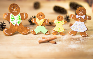 Gingerbread men made on the wooden table plate