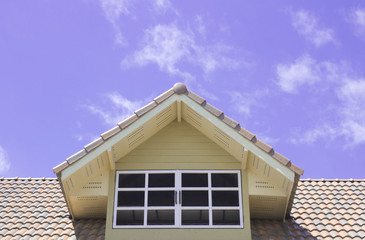 Roof window on blue sky background