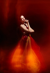 Bright young girl in fluttering red skirt