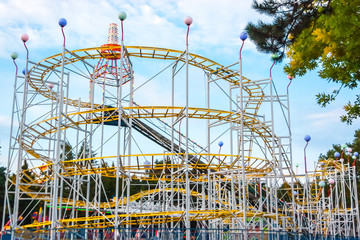 Obraz premium Rollercoaster in the evening against blue sky.