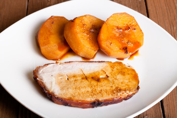 pork with potatoes on old wooden table Shallow depth of field