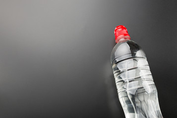 Plastic water bottle on grey background