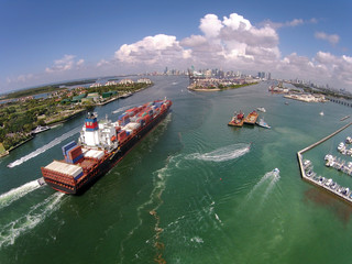 Cargo ship enters port aerial view