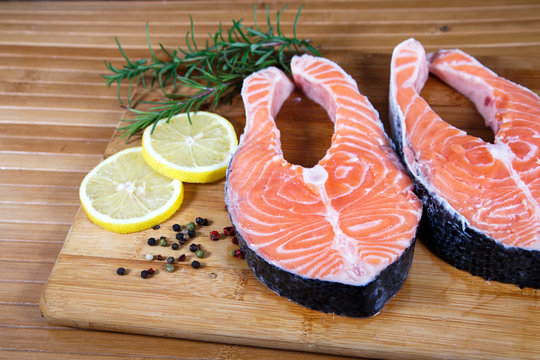 Raw salmon with lemon on wooden table