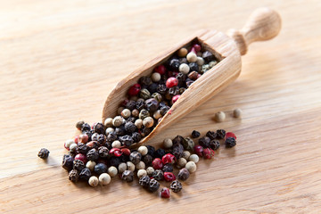 peppercorns on wooden table