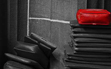 Red cushion on top of the pile - obrazy, fototapety, plakaty