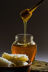 Honeycomb, honey and honey wooden stic