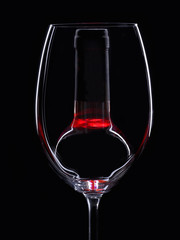 Glass of wine in front of a bottle