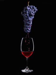 Bunch of Grapes, releasing juice on a glass of wine