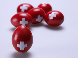 Eggs painted red with a white cross