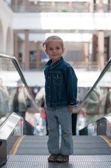 Cute little child in shopping center standing