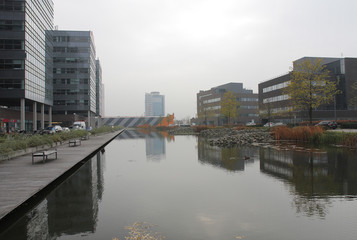 Fototapeta na wymiar Office centre with park and fish-stocked lake.