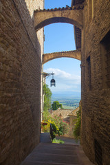 Historic street of Assisi with views of the Umbrian countryside