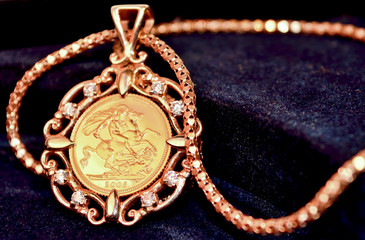 Gold sovereign coin as woman&rsquo;s jewelry pendant on a chain