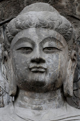 Buddha face sculpture of Longmen Grottoes in Luoyang, China.
