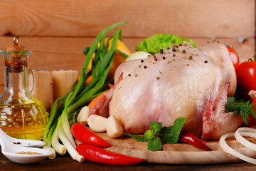 Raw chicken on wooden table