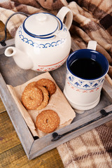 Cup of tea with cookies on table close-up