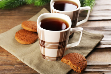 Cups of tea with cookies on table close-up