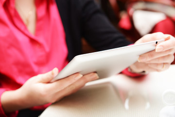 Woman with tablet computer in cafe shop