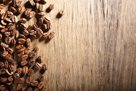 Coffee beans on wooden background © Africa Studio