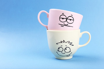 Emotional cups on blue background