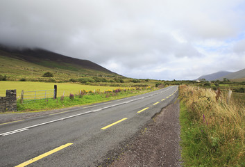 Road with clouds on the hills.