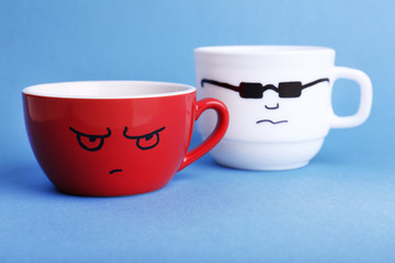 Emotional cups on blue background