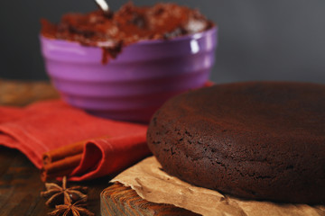 Chocolate pie on wooden table on dark background