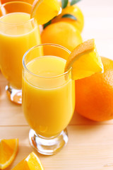 Freshly squeezed orange juice on wooden table