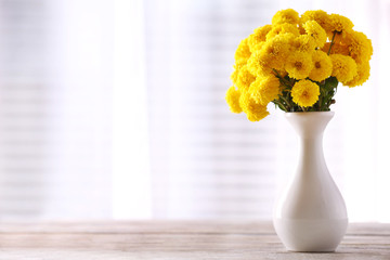 Beautiful flowers in vase with light from window © Africa Studio