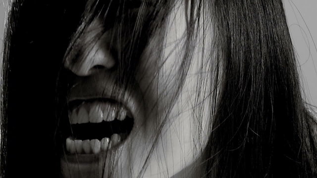 Female asian monster screaming slow motion black and white
