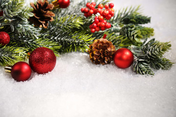 Fototapeta na wymiar Christmas composition with baubles and fir-tree on snow