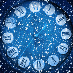 Snow-covered clock on abstract blue background