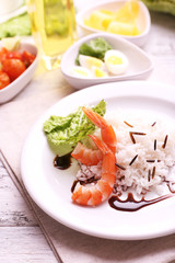 Boiled rice with shrimps served on table, close-up