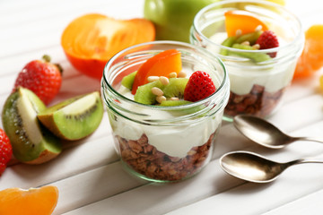 Healthy dessert with muesli and fruits on table