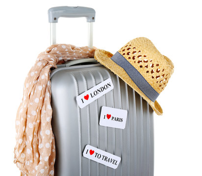 Travel suitcase, scarf and hat isolated on white