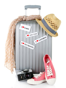 Travel suitcase, converse, photo camera and hat isolated