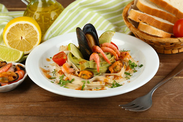 Tasty pasta with shrimps, mussels, tomatoes
