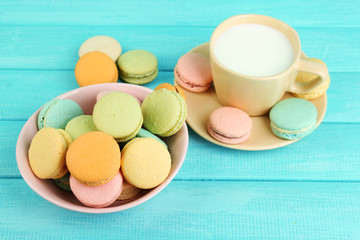 Assortment of gentle colorful macaroons in colorful bowl and