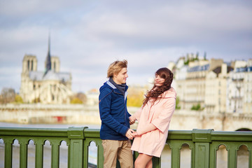 Fototapeta na wymiar Happy dating couple walking in Paris