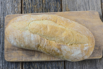 Bread on a Bread Board with Rustic Wood Background
