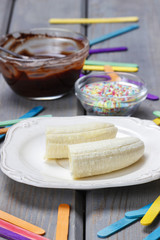 Preparing chocolate dipped bananas dessert