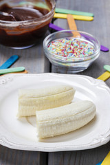 Preparing chocolate dipped bananas dessert
